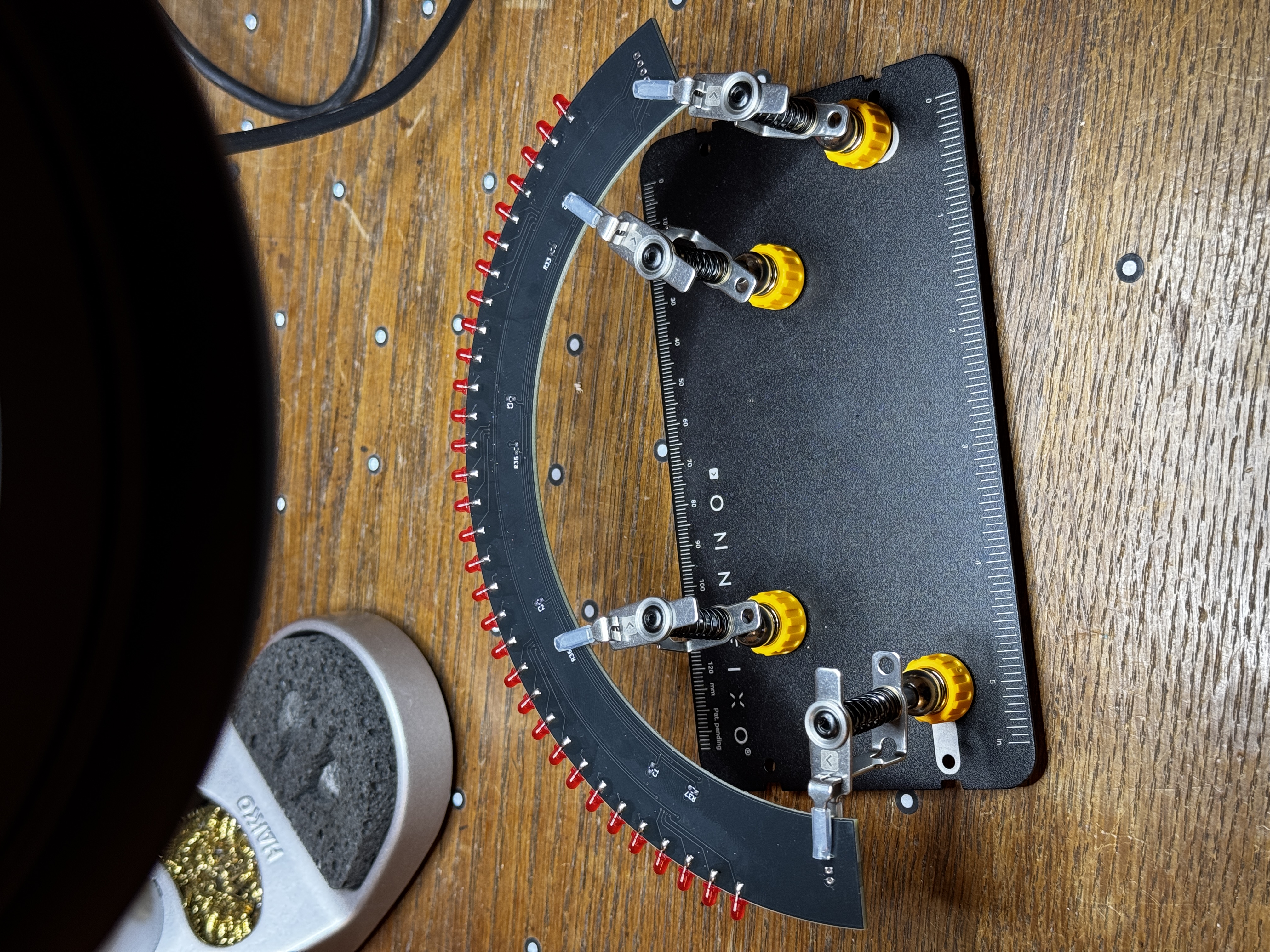 Board held in a soldering stand during assembly